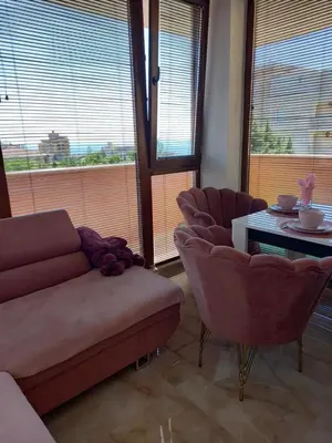 a living room with a couch and chairs and a table at Perla 1 apartments in Ravda