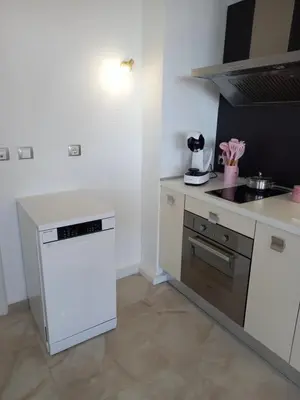 a kitchen with a stove and a white refrigerator at Perla 1 apartments in Ravda