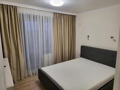 a bedroom with a bed in front of a window at Apartment on the beach 2 in Ravda