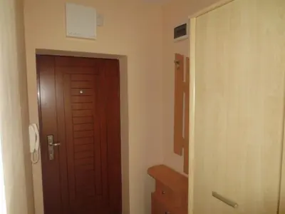 a room with a wooden door and a hallway at Apartment Mihaela in Burgas City