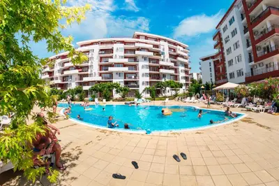 a large swimming pool in front of a building at Panorama Fort Beach in Sveti Vlas