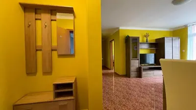 a room with yellow walls and wooden cabinets and a kitchen at ANITA C 19 Apartment Sunny Beach in Sunny Beach