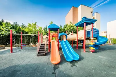 a playground with a slide and a slideintend at Orchid Fort Garden in Sunny Beach