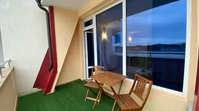 a balcony with a table and chairs and a window at ESPERANTO 401 Large Studio Sunny Beach in Sunny Beach