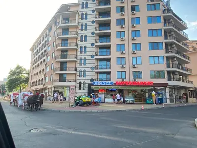 a tall apartment building with a horse standing in front of it at ESPERANTO 401 Large Studio Sunny Beach in Sunny Beach