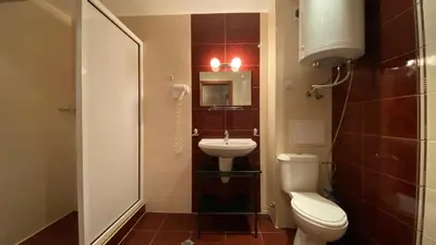 a small bathroom with a toilet and a sink at ESPERANTO 402 Large Studio Sunny Beach in Sunny Beach
