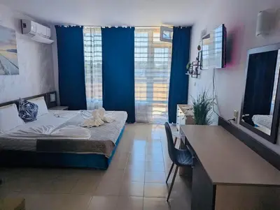 a hotel room with a bed and a desk and a desk at ESPERANTO 403 Large Studio Sunny Beach in Sunny Beach