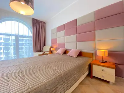 a bedroom with a large bed and a large window at Cascadas Family Resort - Private apartment - BSR in Sunny Beach