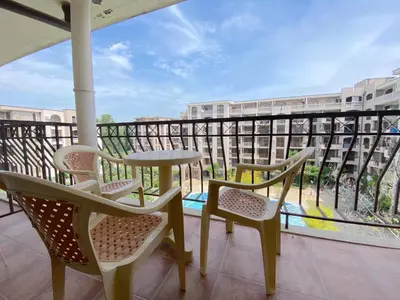 a balcony with two chairs and a table and a table at Cascadas Family Resort - Private apartment - BSR in Sunny Beach