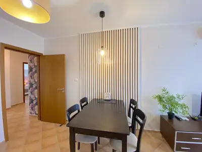 a dining room with a black table and chairs at Cascadas Family Resort - Private apartment - BSR in Sunny Beach