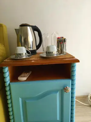 a blue table with a coffee maker on top of it at Стаи за гости Димитрови in Burgas City