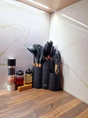 a shelf with several utensils in holders on a wall at FS Apartments Varna - Beautiful apartment in the center of Varna in Varna City