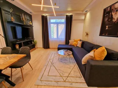 a living room with a blue couch and a table at FS Apartments Varna - Beautiful apartment in the center of Varna in Varna City