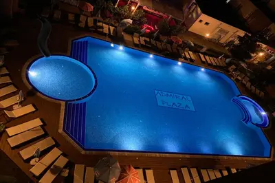 an overhead view of a swimming pool at night at Menada Admiral Plaza Apartaments in Sunny Beach