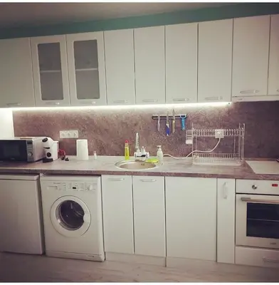 a kitchen with a sink and a washing machine at Апартамент Холи in Sozopol