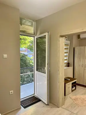 a room with a sliding glass door with a balcony at Home in Varna City