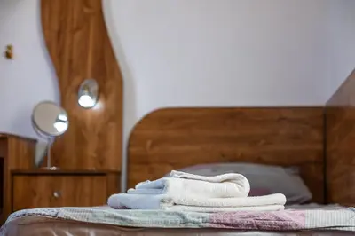 a pile of towels sitting on top of a bed at Roman Thermae 2bdrm Sunny Apartment in Varna City