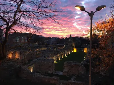 a sunset over a body of water with a street light at Roman Thermae 2bdrm Sunny Apartment in Varna City