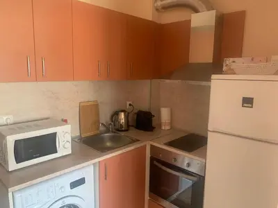 a kitchen with a white microwave and a sink at Studio Fatinia in Byala
