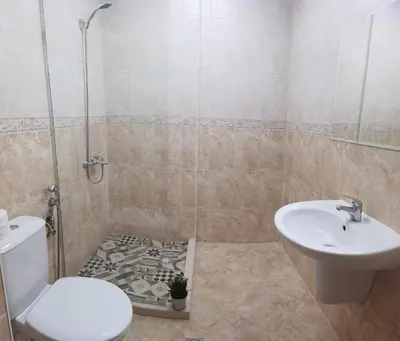 a bathroom with a toilet and a sink and a shower at F 207 Primorsko del Sol - просторно студио с кухня in Primorsko