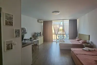 a hotel room with a bed and a kitchen and a living room at F 207 Primorsko del Sol - просторно студио с кухня in Primorsko