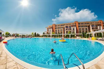 a pool at a resort with people in it at Prestige Mer d'Azur in Sunny Beach