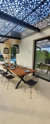 a dining room with a large wooden table and chairs at Luxury Villas Giardino Lozenetz in Lozenets