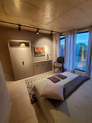 a bedroom with a large bed and a window at Luxury Villas Giardino Lozenetz in Lozenets