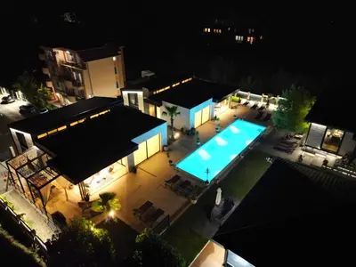 an overhead view of a house with a swimming pool at night at Luxury Villas Giardino Lozenetz in Lozenets