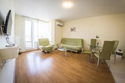 a living room with a couch and chairs and a table at Holiday Garden Resort in Sunny Beach
