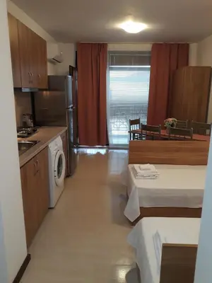 a room with a kitchen and a living room at Апартамент Rose в местност Каваци, Созопол in Sozopol