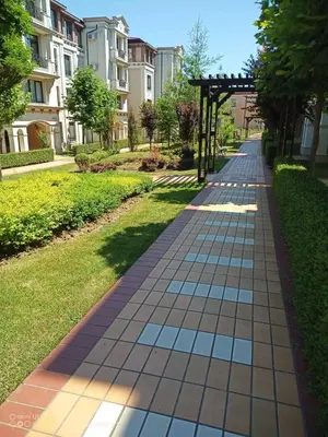 a walkway with a gazebo in a park at Апартамент Rose в местност Каваци, Созопол in Sozopol