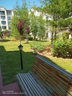 a park bench next to a light pole in a park at Апартамент Rose в местност Каваци, Созопол in Sozopol