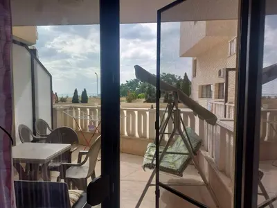 a view of a balcony with a table and a telescope at Studio Sarafovo in Burgas City
