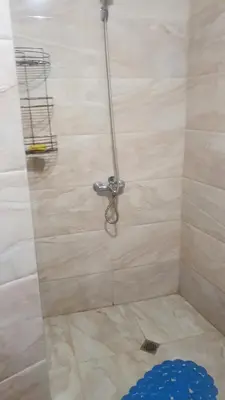 a shower with a hose attached to a wall at Studio Sarafovo in Burgas City