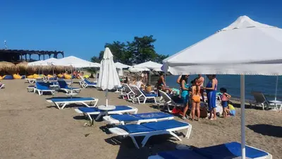 a group of chairs and umbrellas on a beach at Studio Sarafovo in Burgas City
