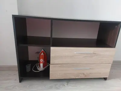 a wooden entertainment center with a red helmet in it at Studio Sarafovo in Burgas City