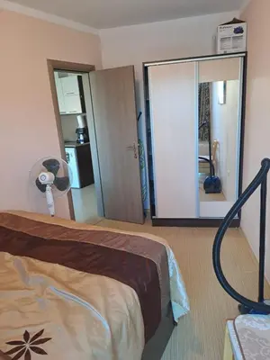 a hotel room with a bed and a mirror at SUNNY BEACH PLAZA Apartments in Sunny Beach