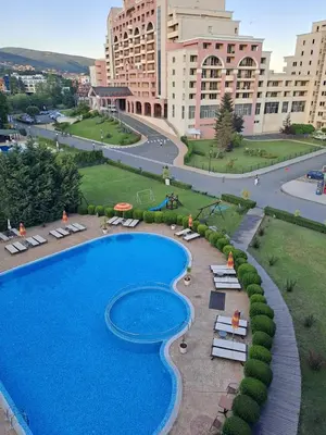 a large swimming pool in front of a large building at SUNNY BEACH PLAZA Apartments in Sunny Beach