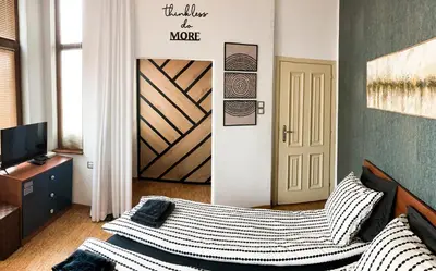 a bedroom with a bed and a door with a sign at Two Bedroom Apartment - Alexandrovska - Top Location - Central Bus, Train and Marine Stations, next to Sea Garden and Beach in Burgas City