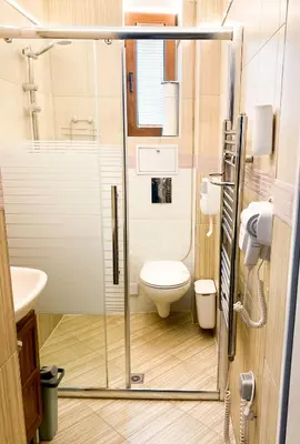 a small bathroom with a toilet and a sink at Two Bedroom Apartment - Alexandrovska - Top Location - Central Bus, Train and Marine Stations, next to Sea Garden and Beach in Burgas City