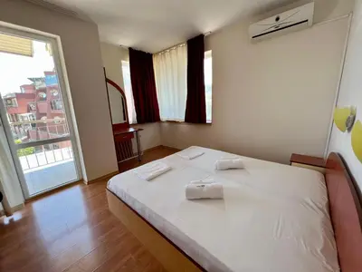 a bedroom with a white bed with two towels on it at Private One-Bedroom Apartment with Balcony in Sozopol by Flat Mаnаger in Sozopol