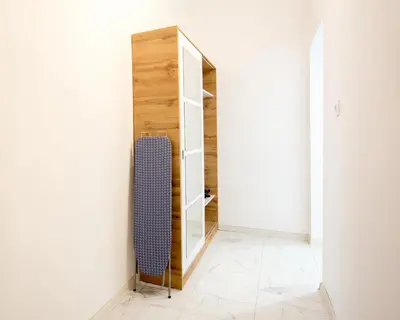 a room with a mirror and a blue chair at Aleks Sunrise -Top Center ,Sea Garden in Burgas City