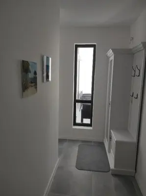 a white room with a staircase and a window at Antique 7 ap.1 in Sozopol