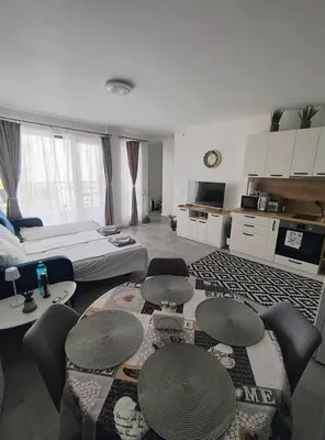 a living room with a couch and tables and chairs at Antique 7 ap.1 in Sozopol