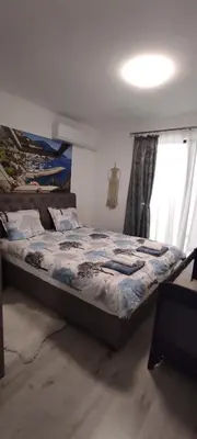 a bedroom with a bed and a window at Antique 7 ap.1 in Sozopol