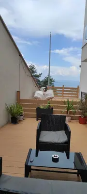 a balcony with a chair and a coffee table at Antique 7 ap.1 in Sozopol