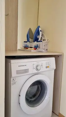 a washing machine with a box on top of it at Oasis deluxe apartment by the sea in Ravda