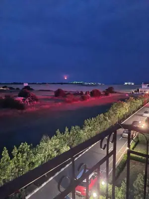 a view of the ocean at night from a balcony at Famagusta Antoniya in Aheloy