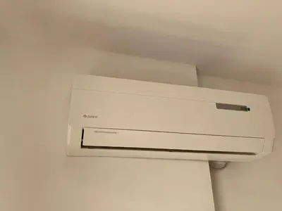 a white air conditioner hanging from a ceiling at Summer Breeze 515 Studio NO ROMANIA in Sunny Beach